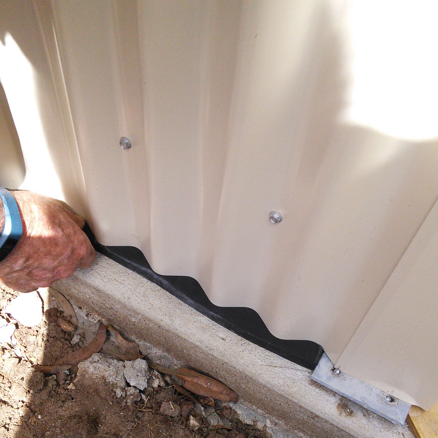 Adhesive Neoprene Foam Tape being installed to seal a garden shed