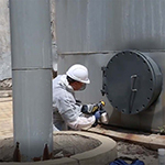 Brushable Liquid Zinc Paint Being Sprayed onto a Access Cover Flange