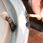 Fast Metal Minute Adhesive being mixed and applied to a stainless steel part