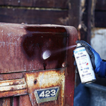 Rust Converter Spray being used on a rusted housing